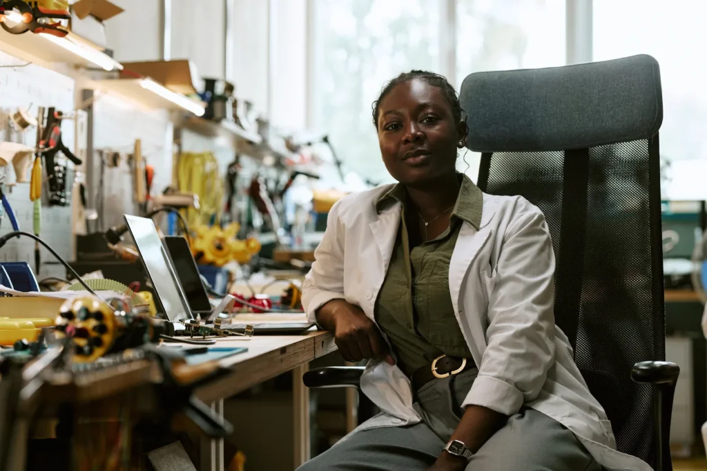 Confident engineer sitting in her workshop