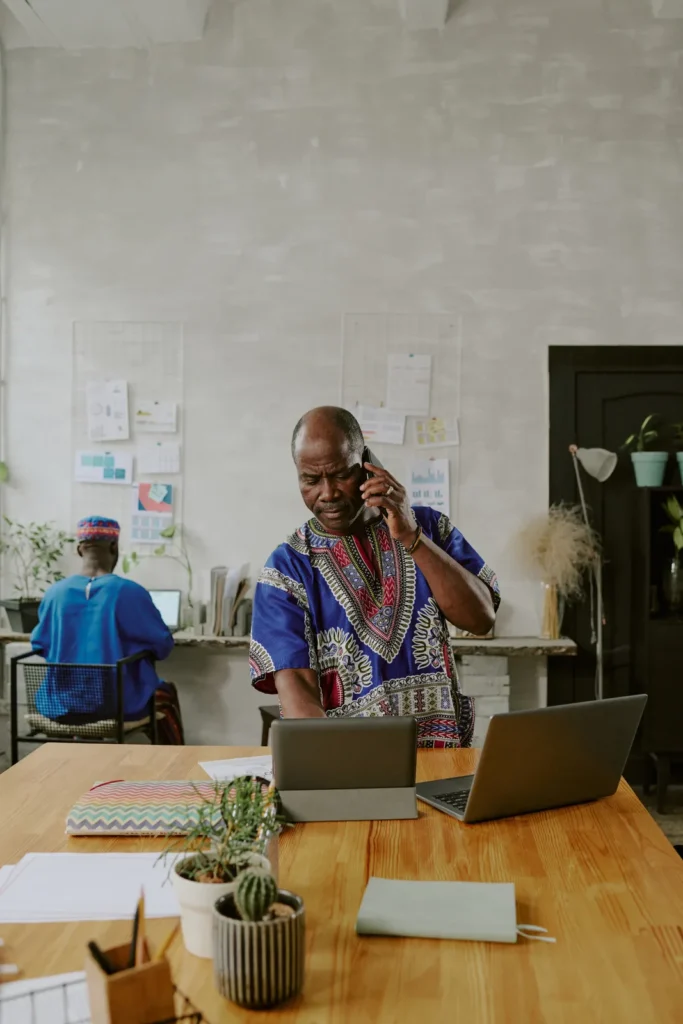 Business owner on a phone call at his office desk